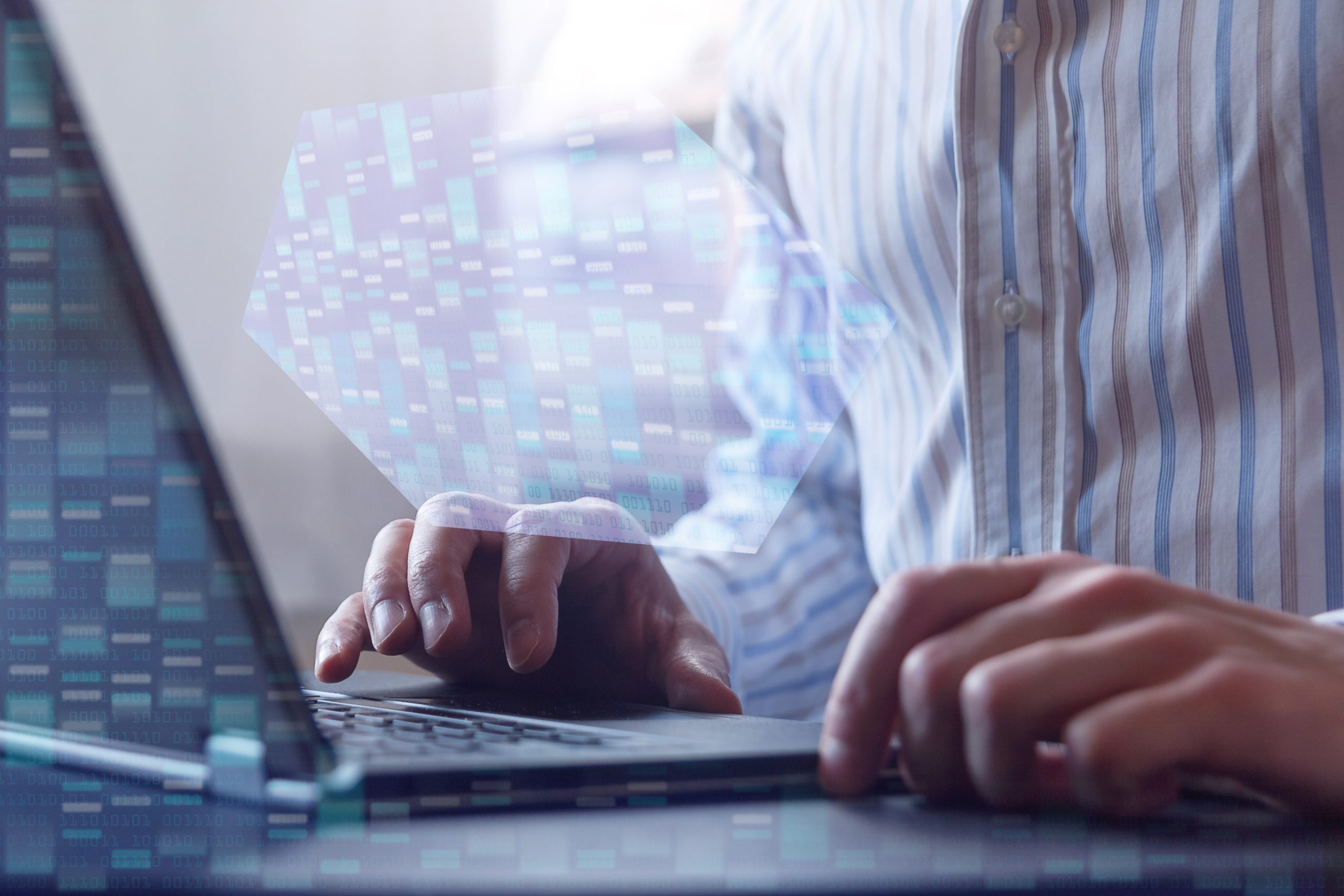 Man working on laptop with genome map sequencing overlaying the image