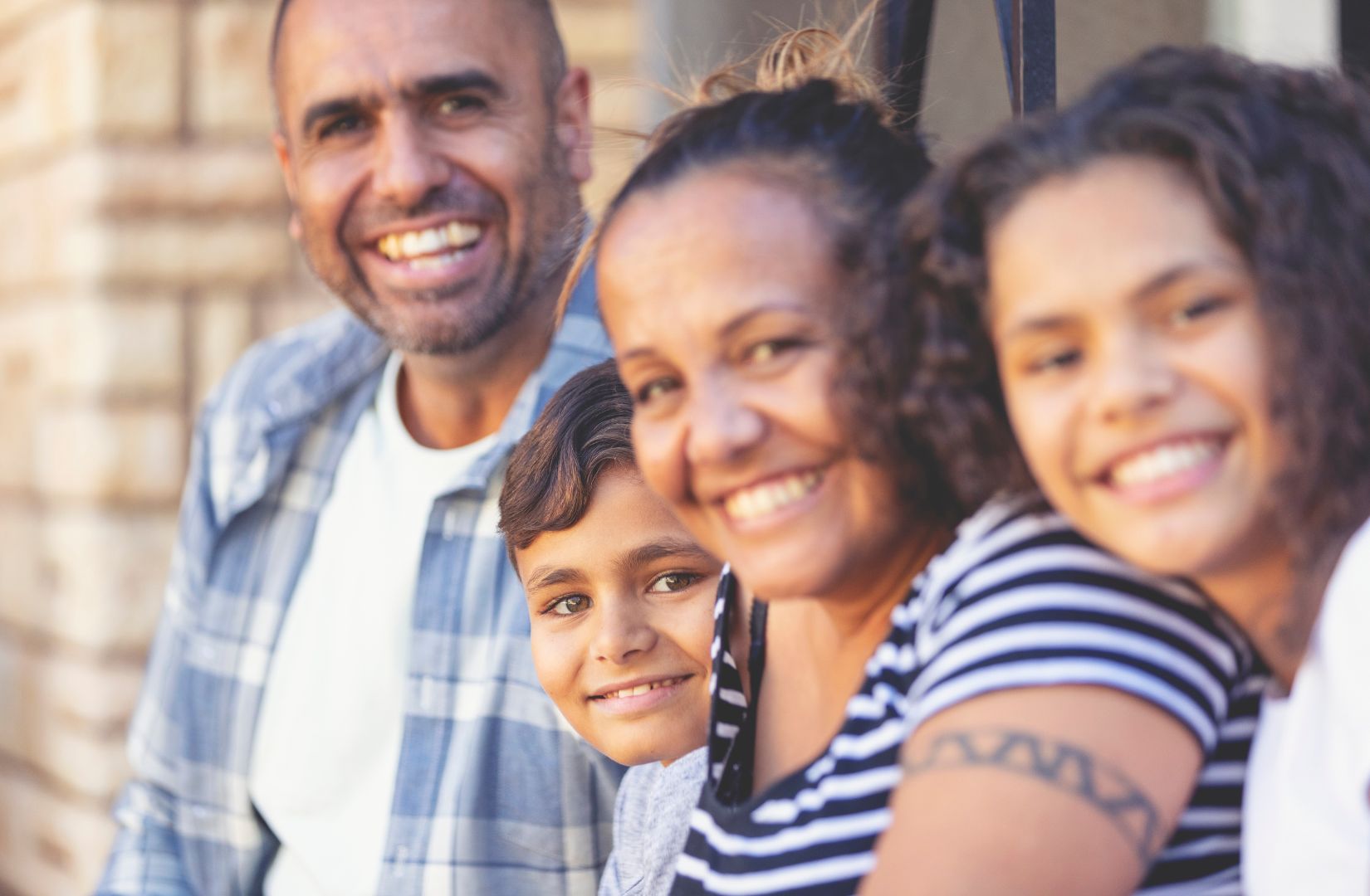 Family smiling at the camera.